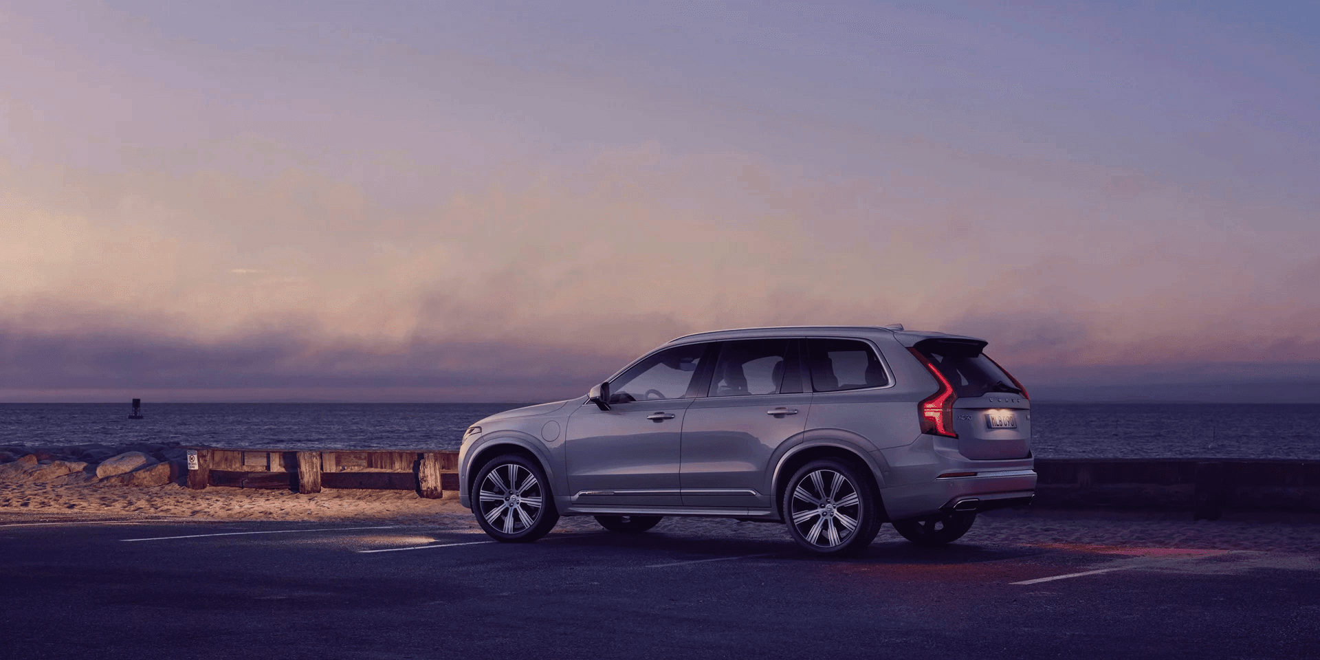 Luxury SUV on a coastal road at dusk